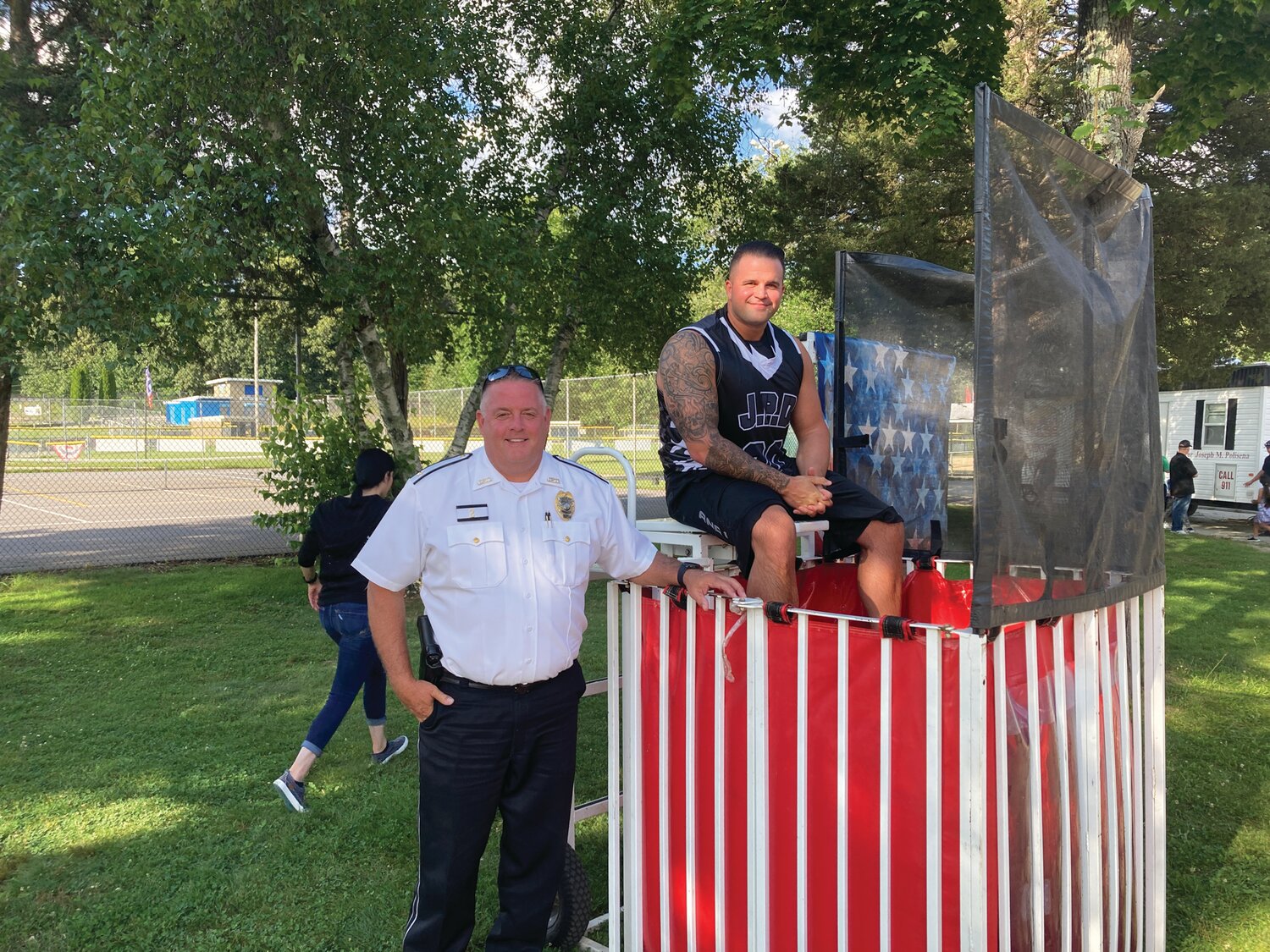 CHILLING OUT: Deputy Chief Matthew LeDuc ensured the water level in the dunk tank was high enough to cover Officer Louis Cotoia.